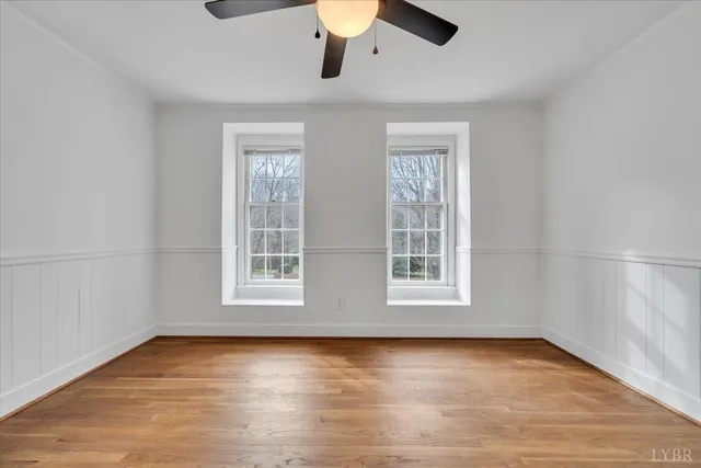 a view of an empty room with a fireplace and a window