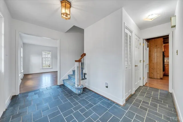a view of empty room with wooden floor and fireplace
