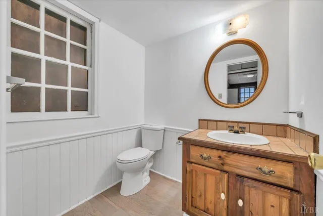 a front view of a house with a yard covered with snow