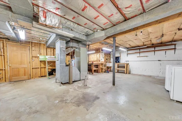 a view of a house with a yard and large tree