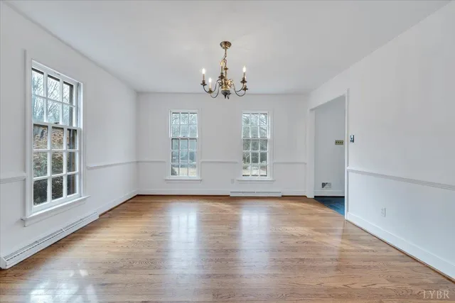 a kitchen with stainless steel appliances granite countertop a refrigerator a sink dishwasher a stove with wooden cabinets and floor