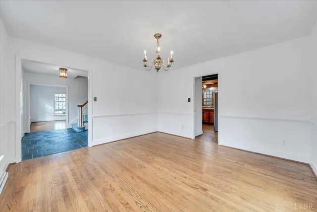 a view of a entrance and room with wooden floor