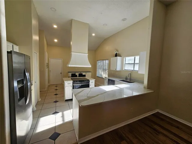 a kitchen with a refrigerator and a sink