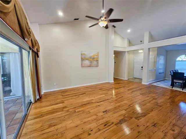 a view of empty room with wooden floor