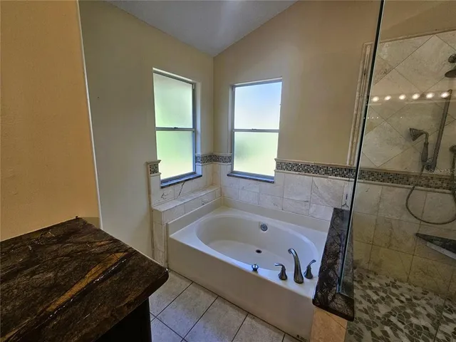 a bathroom with a tub and a window