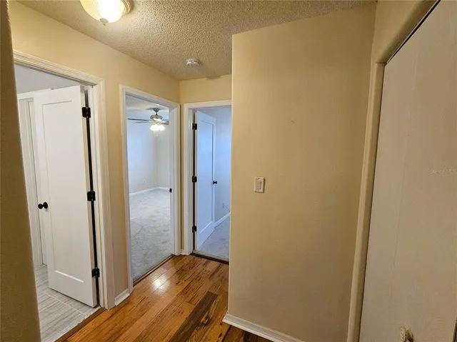 a view of a hallway with wooden floor