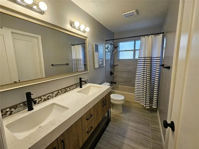 a bathroom with a sink double vanity and a toilet