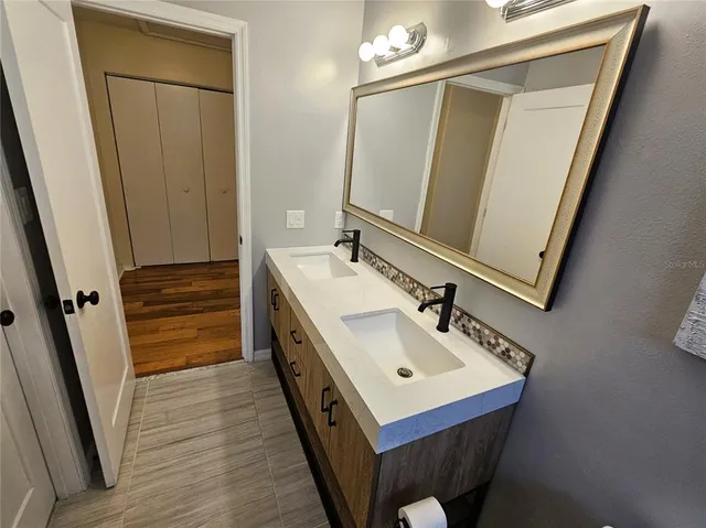a bathroom with a sink a mirror and a toilet