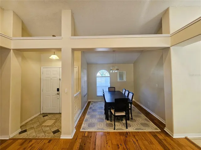 a view of a hallway with furniture and wooden floor