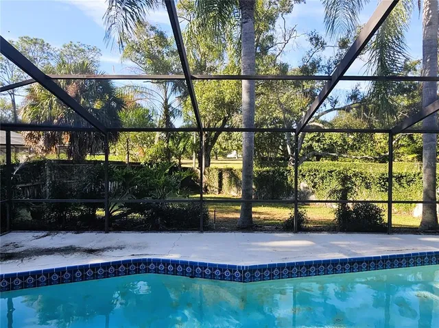 a view of swimming pool with a yard and sitting area
