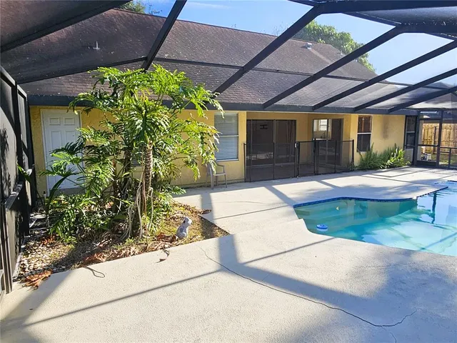 a patio with a table and chairs under an umbrella