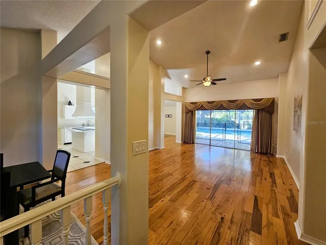 a view of a workspace with wooden floor and a bathroom