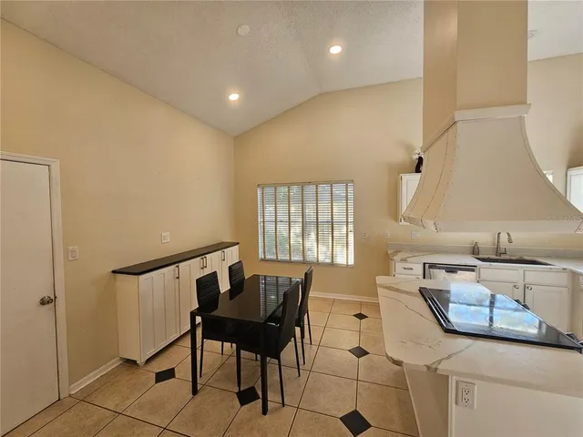 a hallway with a table and chairs