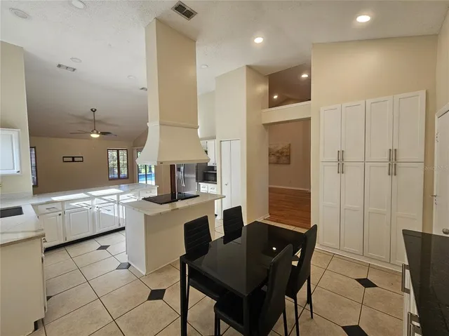 a kitchen with a sink and chairs