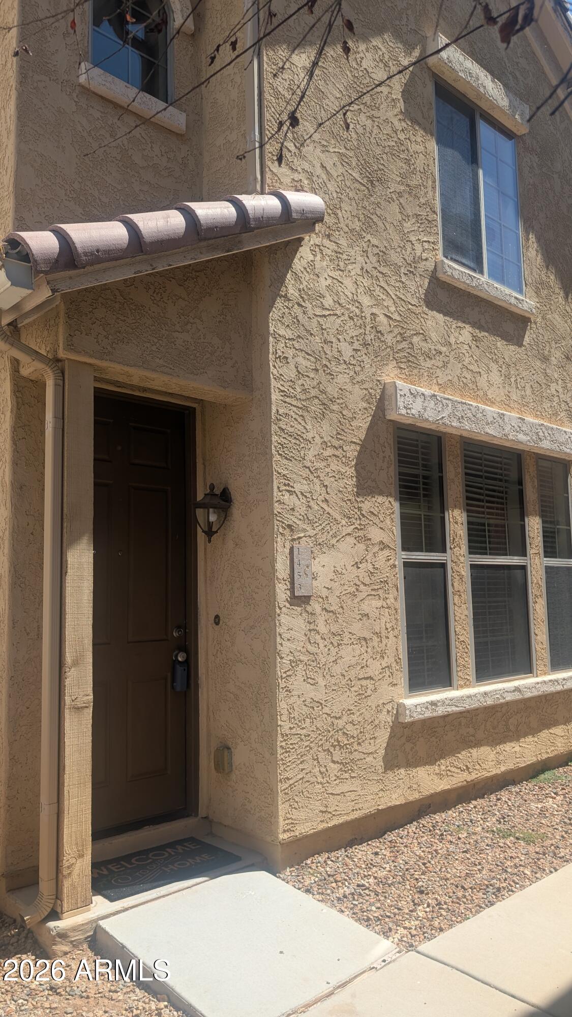 1453 South Sinova Avenue Gilbert, AZ 85296 - Photo 1 of 46 a front view of a house with a shower