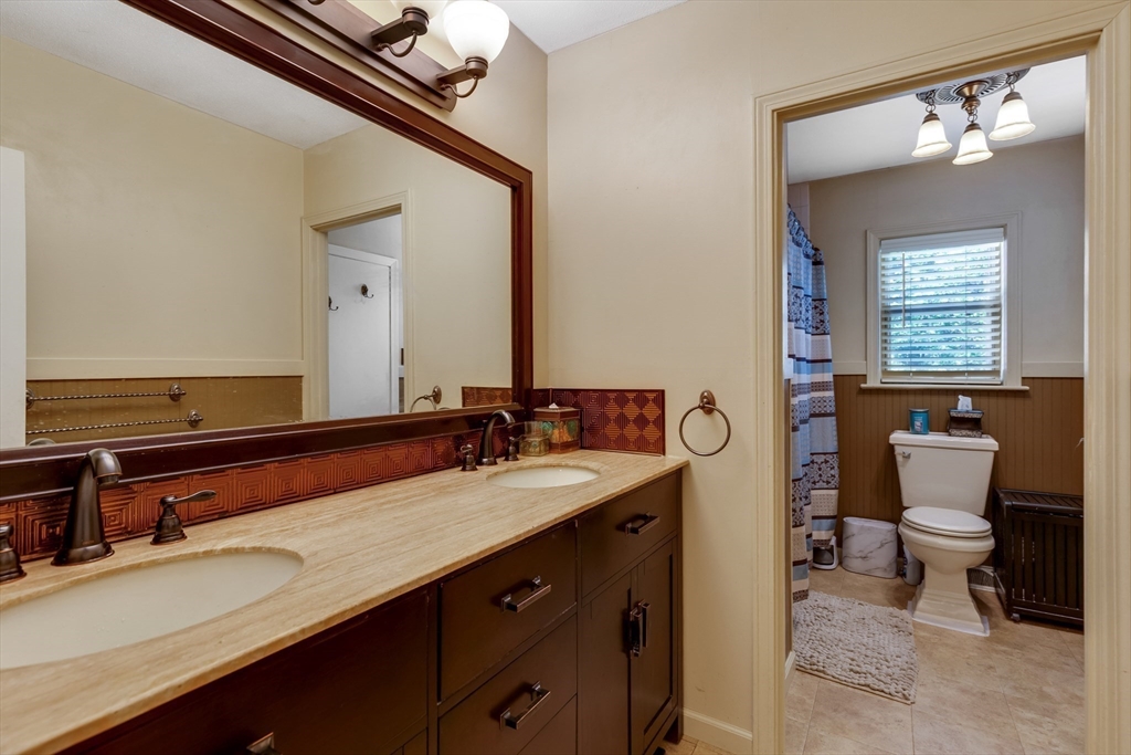 15 Conestoga Road Lexington, MA 02421 - Photo 14 of 31 a bathroom with a sink a toilet and a mirror