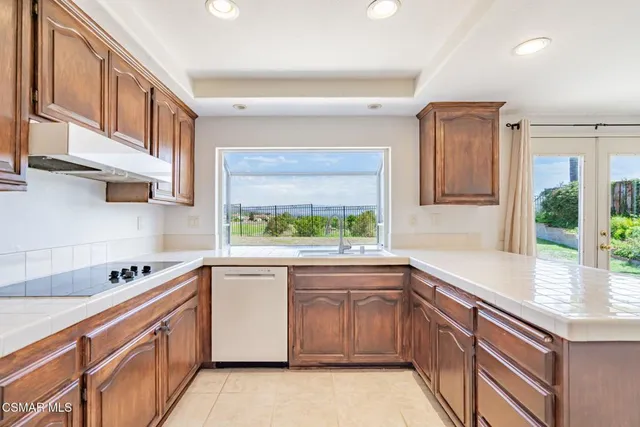 a kitchen with stainless steel appliances a sink stove and cabinets