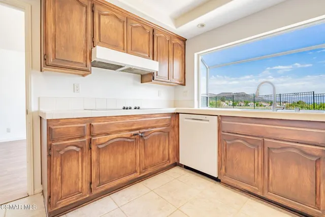 a kitchen with stainless steel appliances granite countertop a sink and cabinets