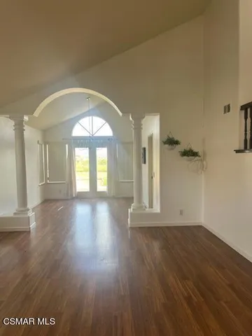 wooden floor in an empty room with a window