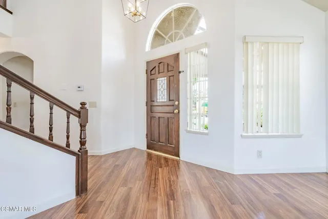 a view of an entryway with wooden floor