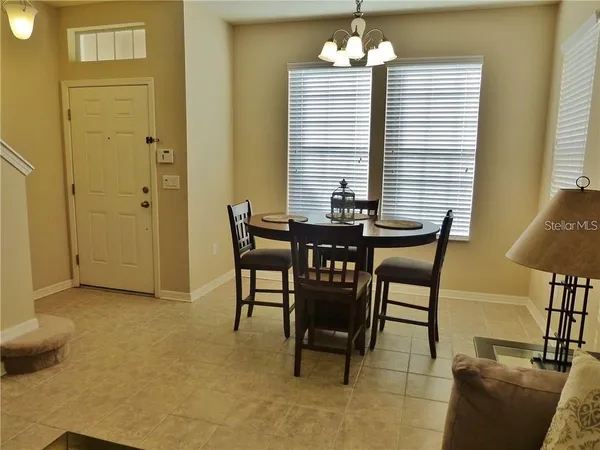 a view of a dining room with furniture and a chandelier