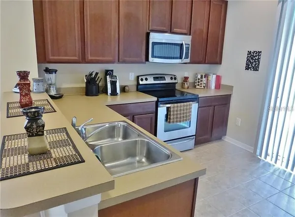 a kitchen with a sink stove and cabinets