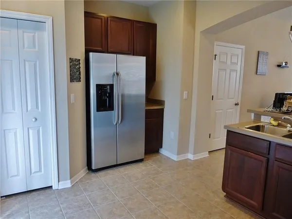 a kitchen with a refrigerator and a stove