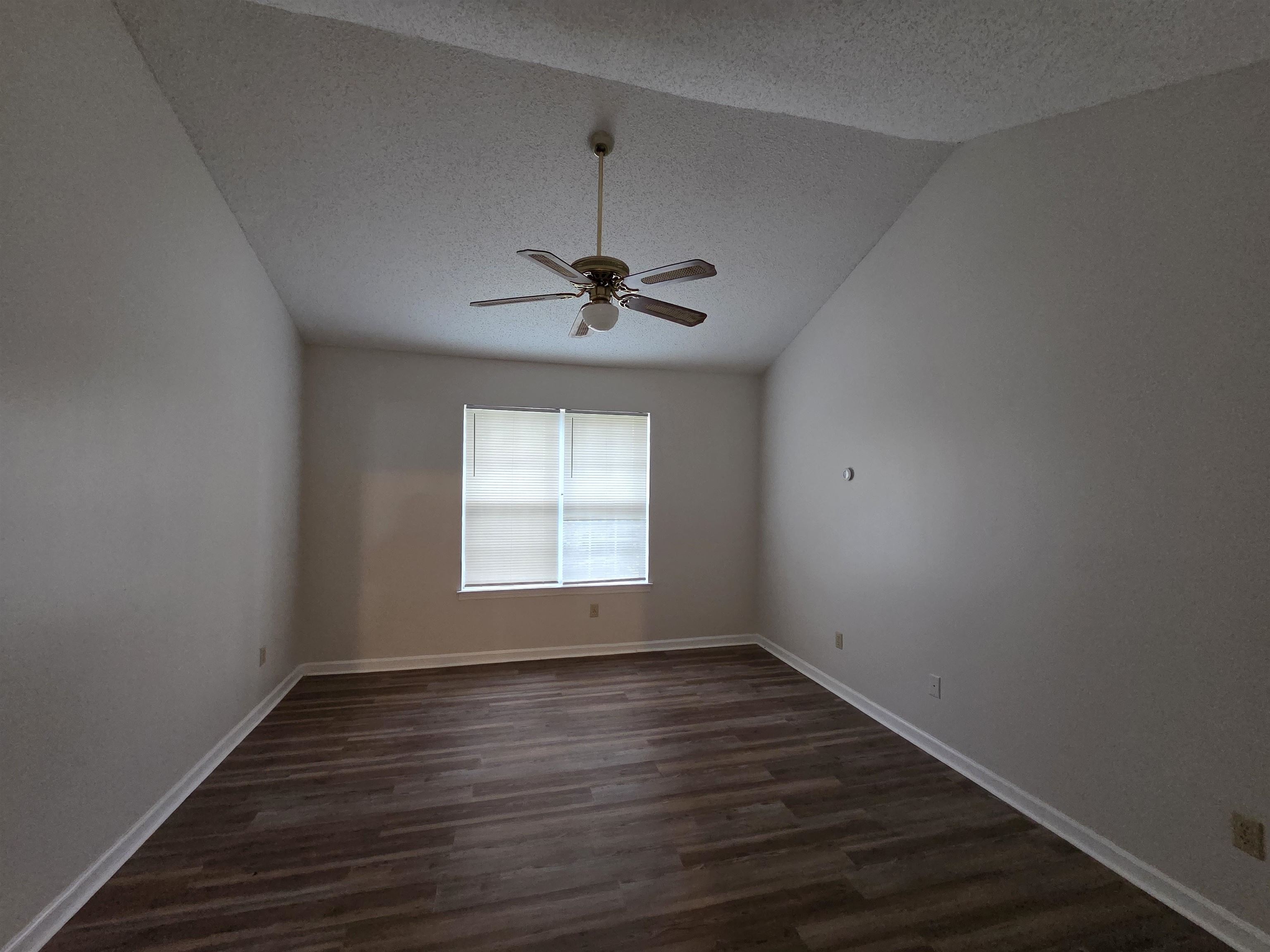 3945 Oak Branch Circle East Memphis, TN 38135 - Photo 11 of 24 a view of empty room with wooden floor and fan