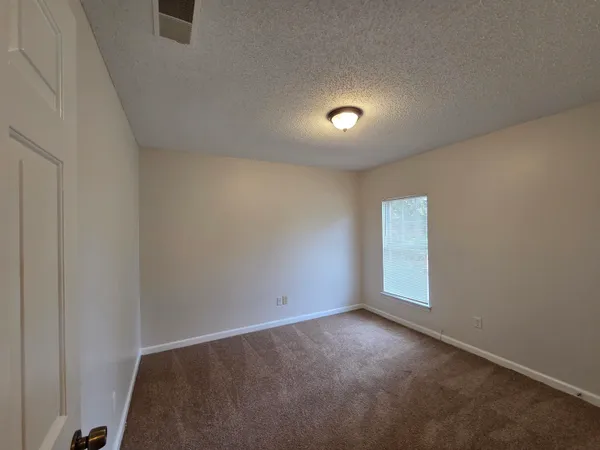 an empty room with a empty space and a window