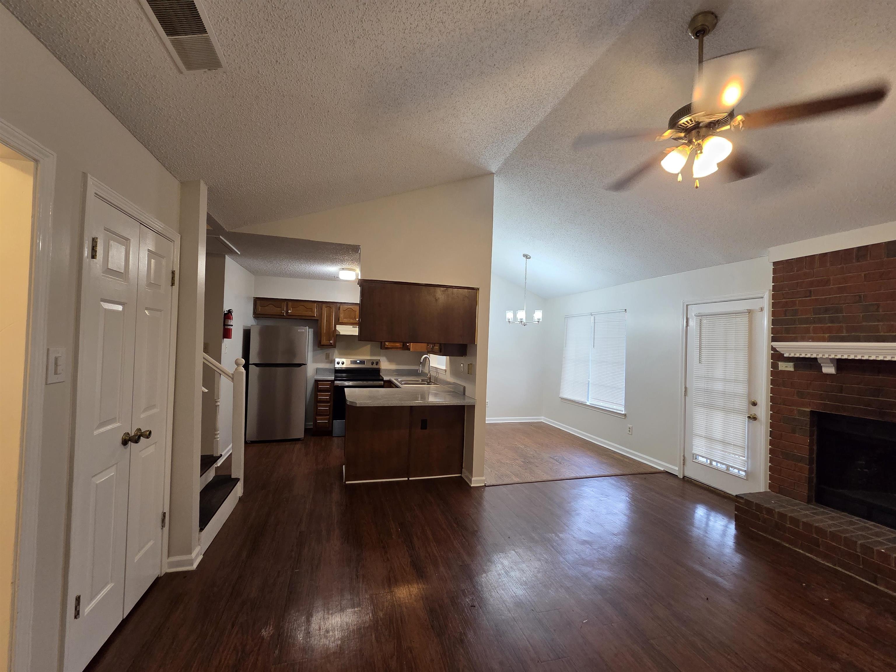 3945 Oak Branch Circle East Memphis, TN 38135 - Photo 24 of 24 a view of a kitchen with a sink stove refrigerator and wooden floor
