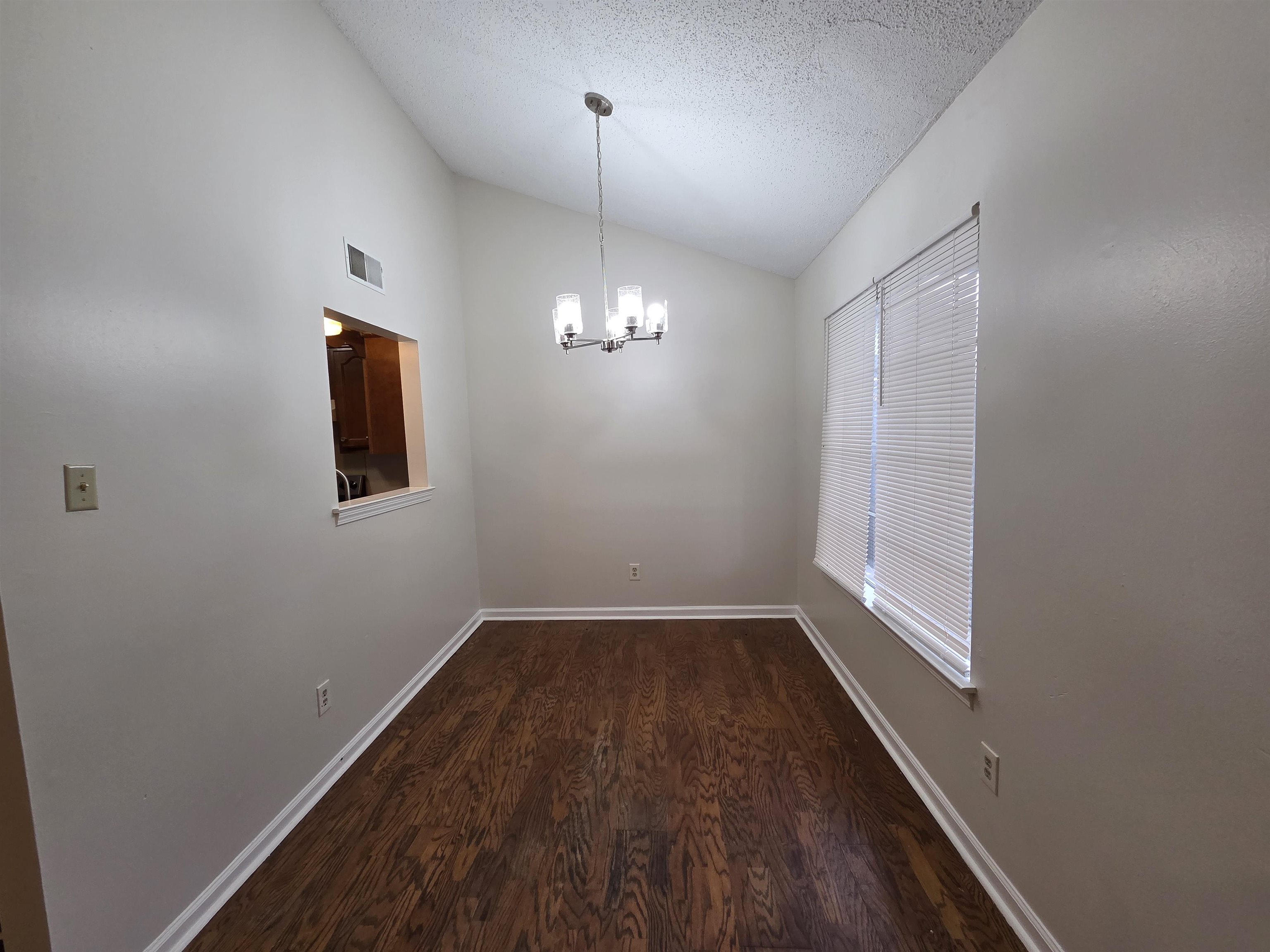 3945 Oak Branch Circle East Memphis, TN 38135 - Photo 10 of 24 wooden floor in an empty room with a window