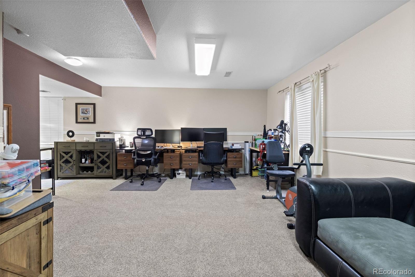 10565 Hyacinth Place Highlands Ranch, CO 80129 - Photo 26 of 33 a living room with lots of furniture and a window