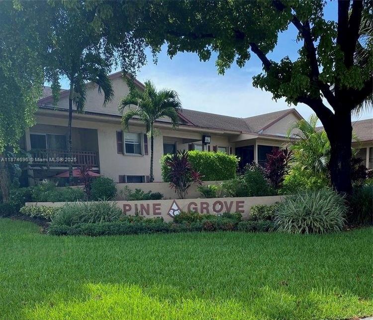 11295 Southwest 88th Street, Unit M109 Miami, FL 33176 - Photo 1 of 10 a front view of a house with a garden