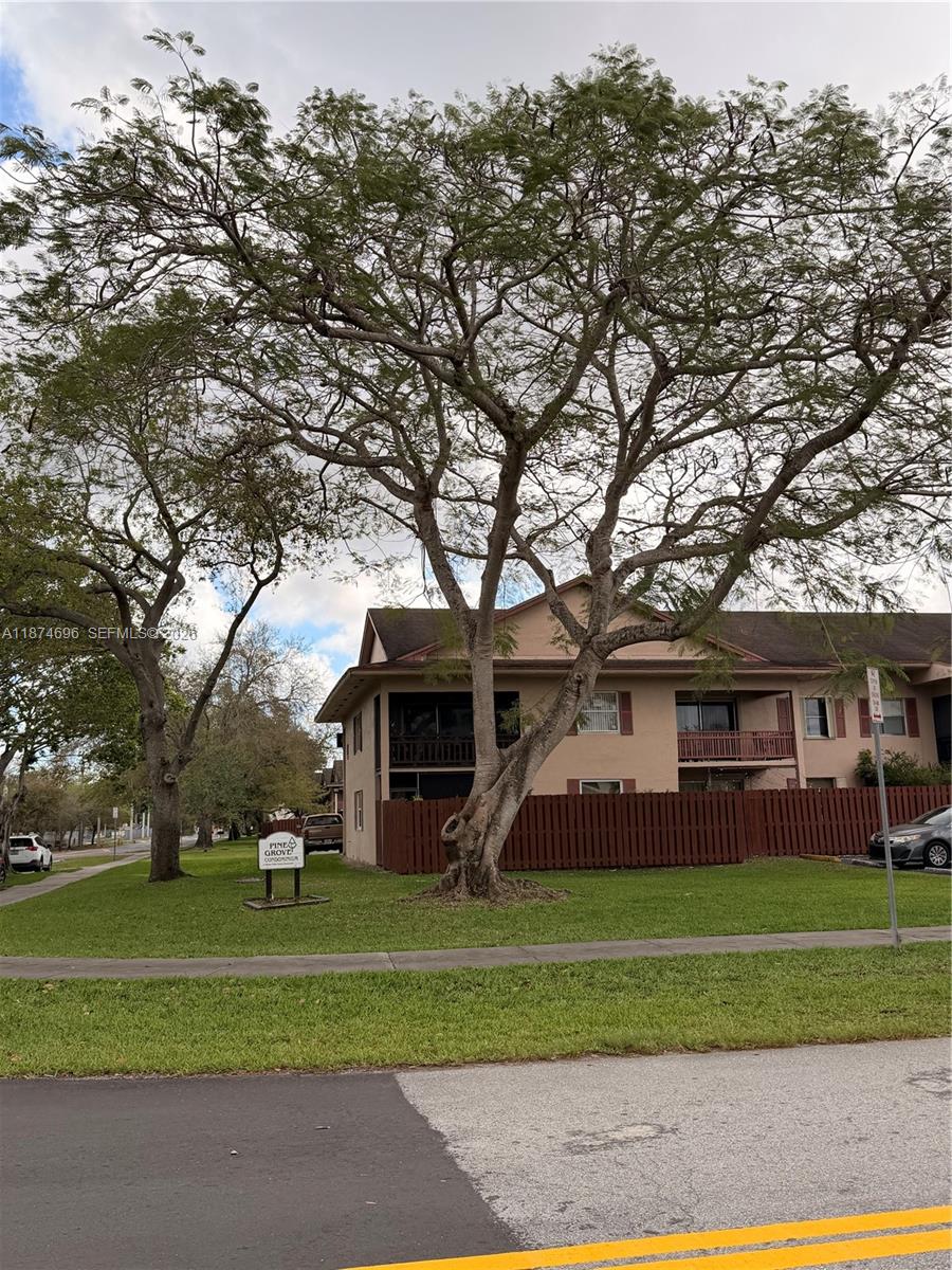 11295 Southwest 88th Street, Unit M109 Miami, FL 33176 - Photo 12 of 17 a front view of a house with a yard