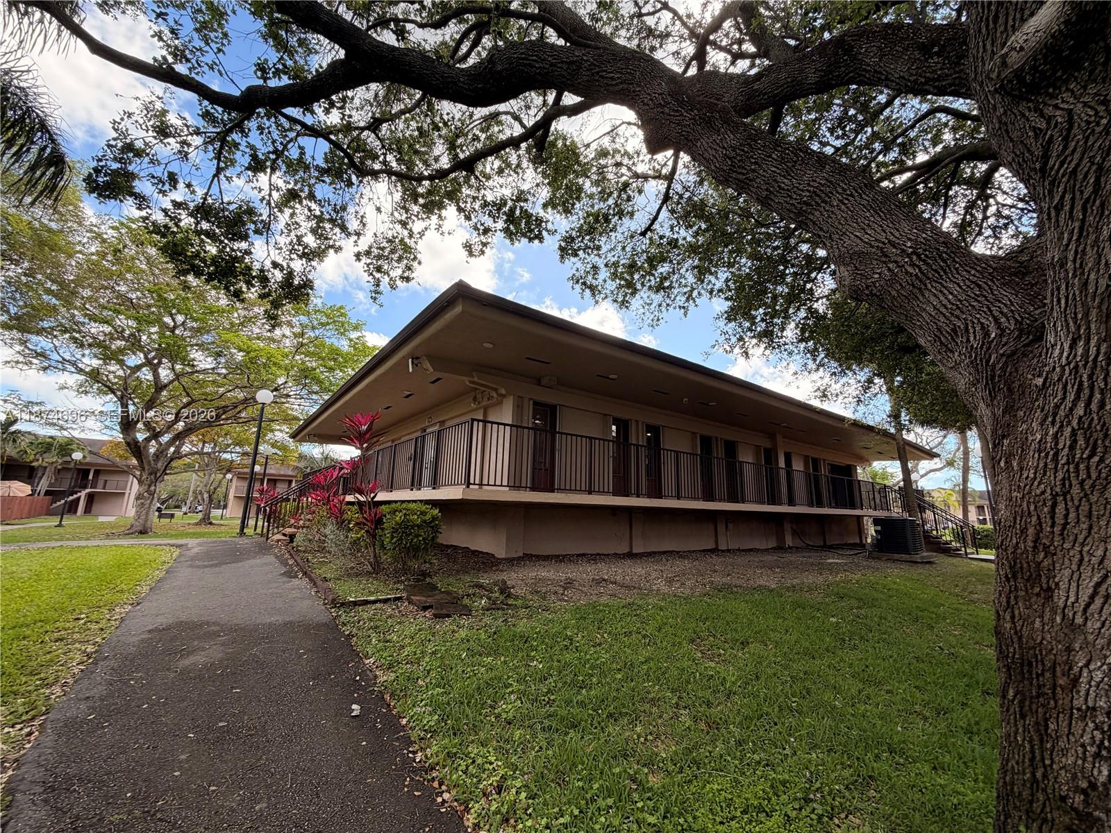 11295 Southwest 88th Street, Unit M109 Miami, FL 33176 - Photo 14 of 17 a house with a yard