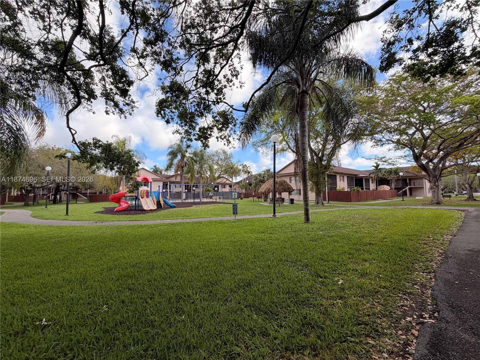11295 Southwest 88th Street, Unit M109 Miami, FL 33176 - Photo 15 of 17 a view of a park with palm trees