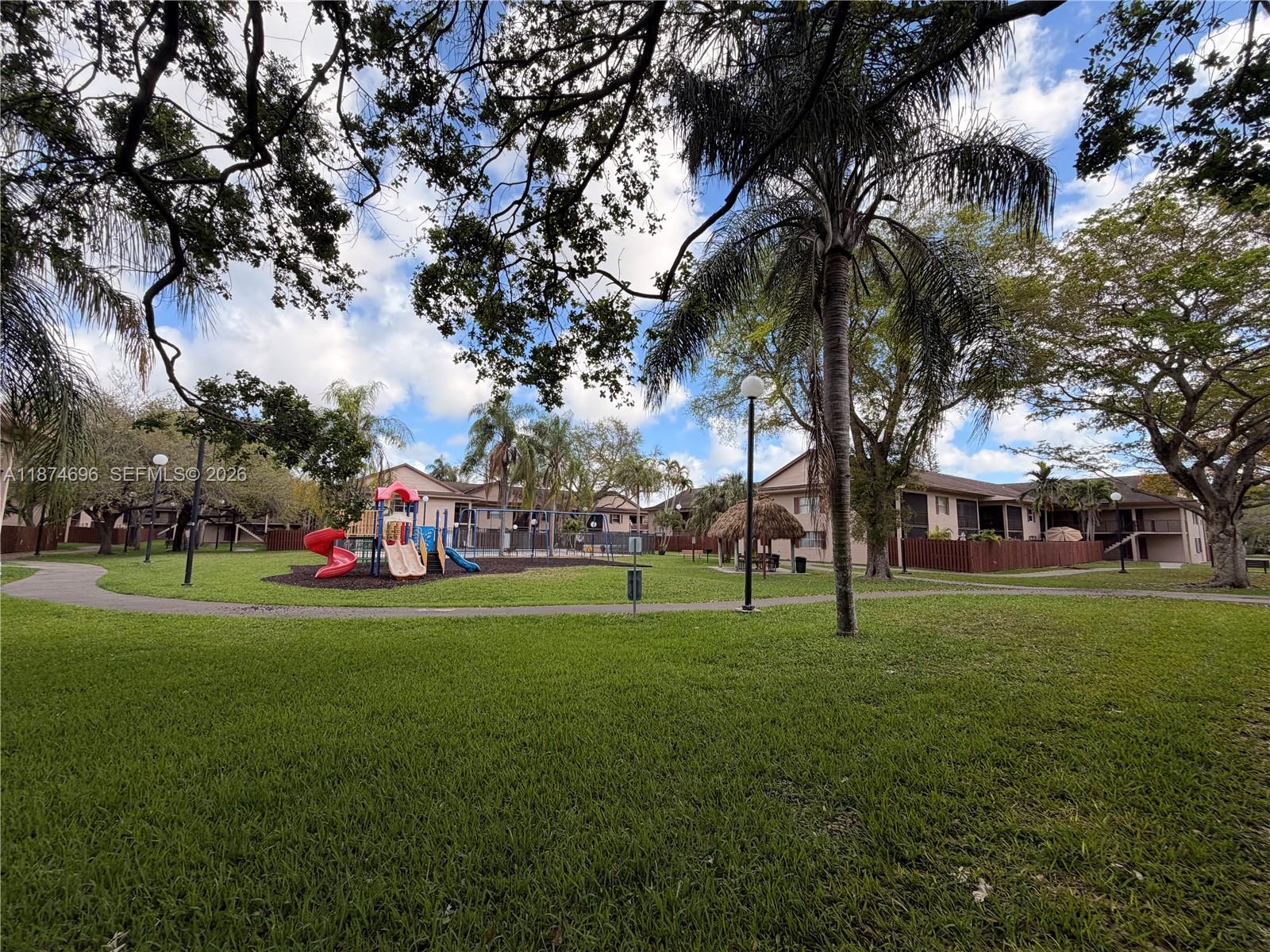11295 Southwest 88th Street, Unit M109 Miami, FL 33176 - Photo 16 of 17 a view of a park with large trees