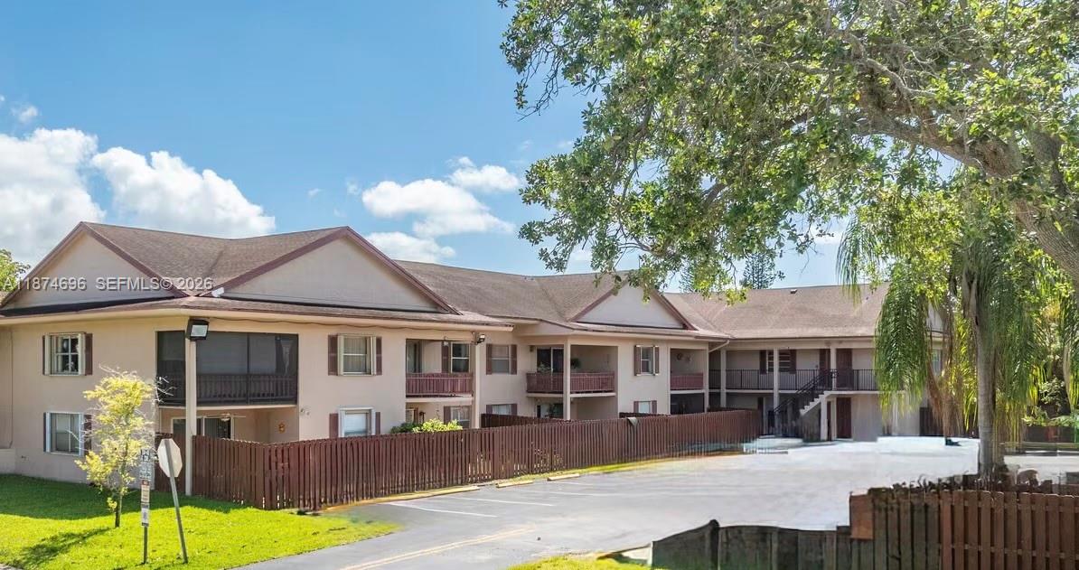 11295 Southwest 88th Street, Unit M109 Miami, FL 33176 - Photo 3 of 17 a front view of a house with a yard