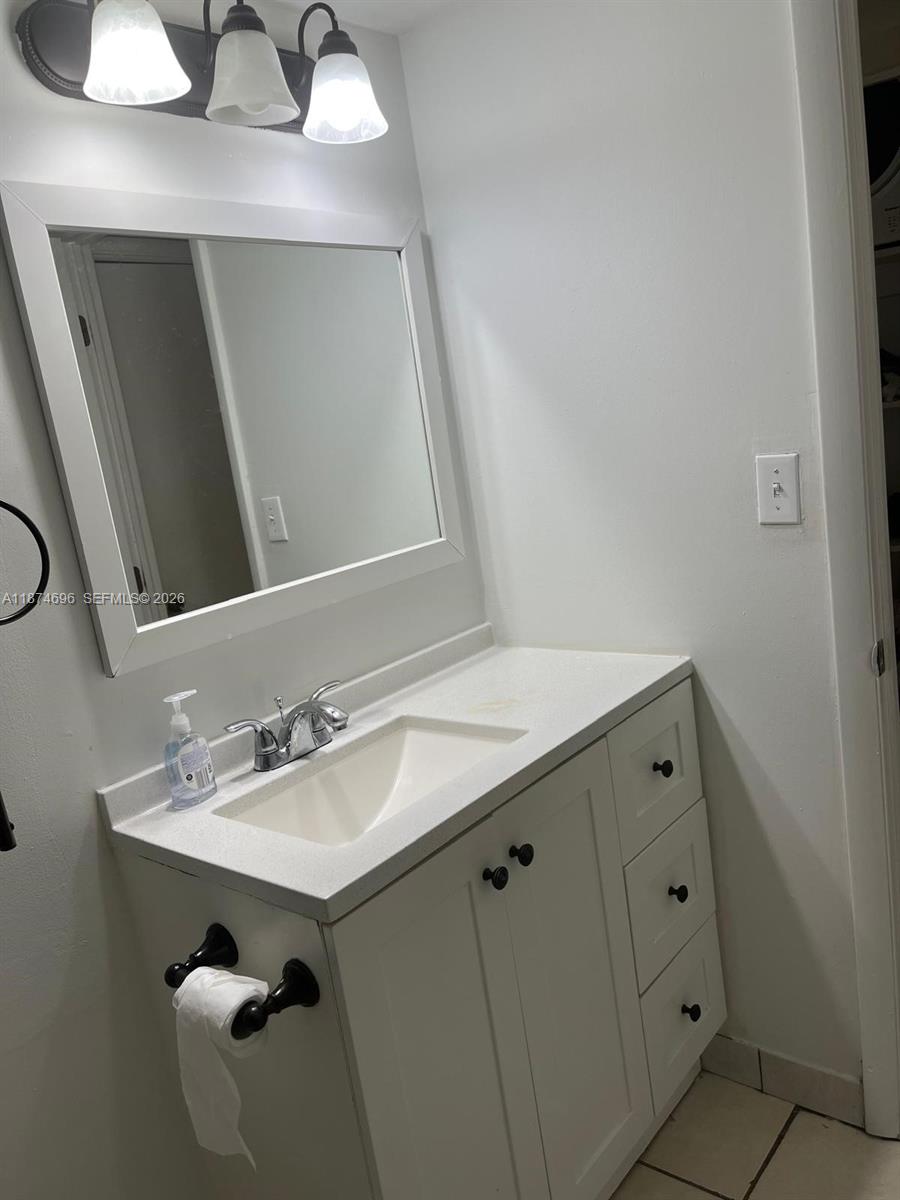 11295 Southwest 88th Street, Unit M109 Miami, FL 33176 - Photo 7 of 17 a bathroom with a sink vanity and mirror