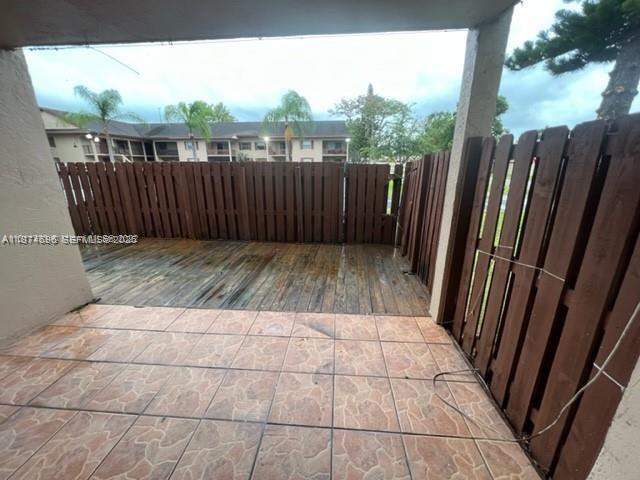 11295 Southwest 88th Street, Unit M109 Miami, FL 33176 - Photo 10 of 17 a view of wooden floor with a wooden fence