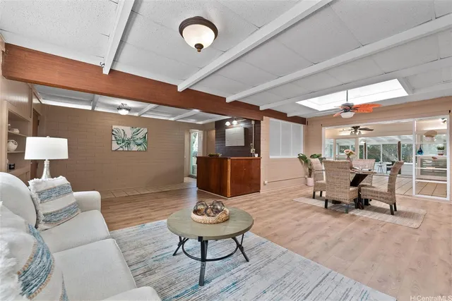 a living room with furniture a rug and a chandelier