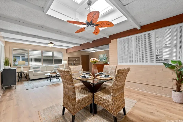 a dining room with furniture and a large window