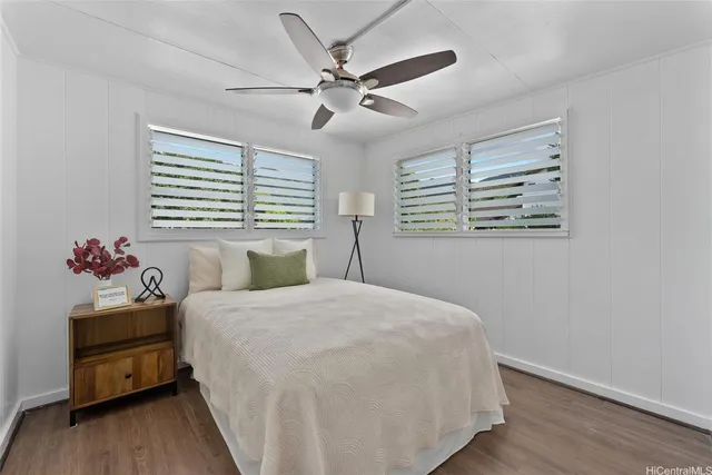 a bedroom with a bed dresser and a window