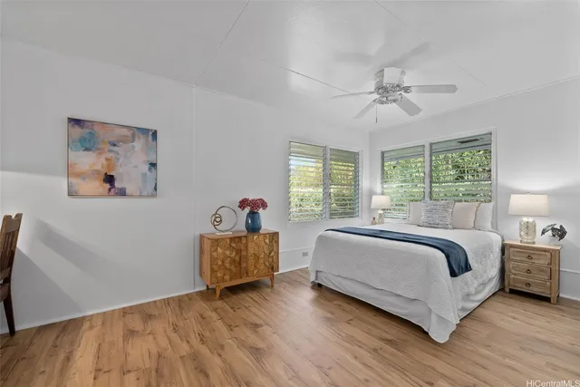 a bedroom with a bed and a painting on the wall