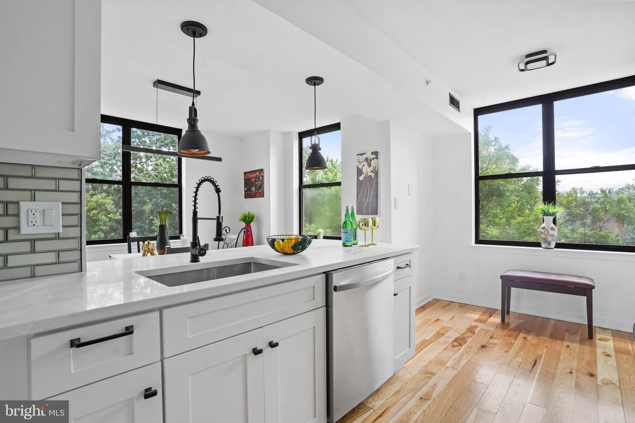 5000 Battery Lane, Unit 501 Bethesda, MD 20814 - Photo 12 of 21 a kitchen with sink cabinets and wooden floor