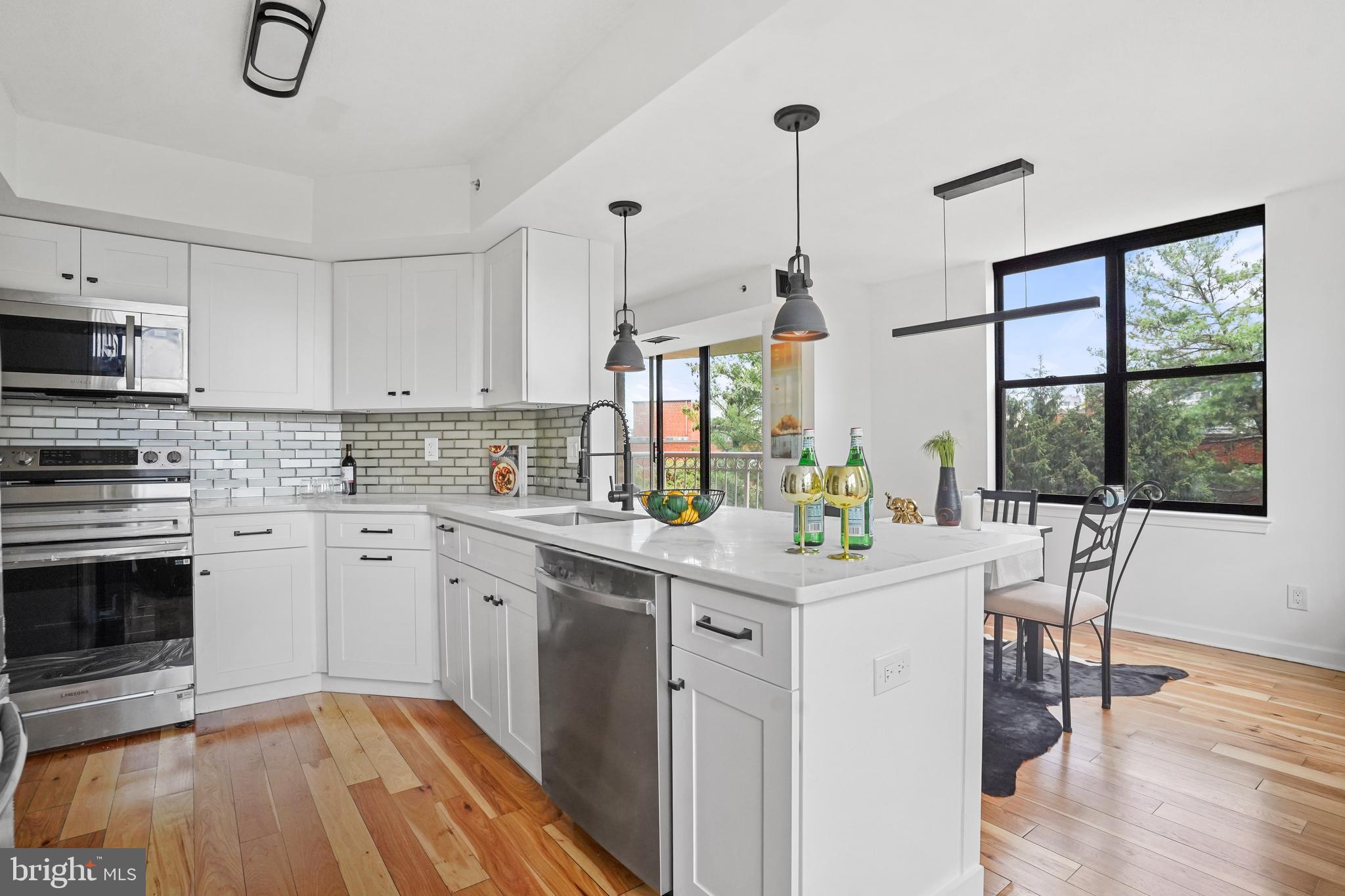 5000 Battery Lane, Unit 501 Bethesda, MD 20814 - Photo 13 of 21 a kitchen with stainless steel appliances granite countertop a stove and white cabinets