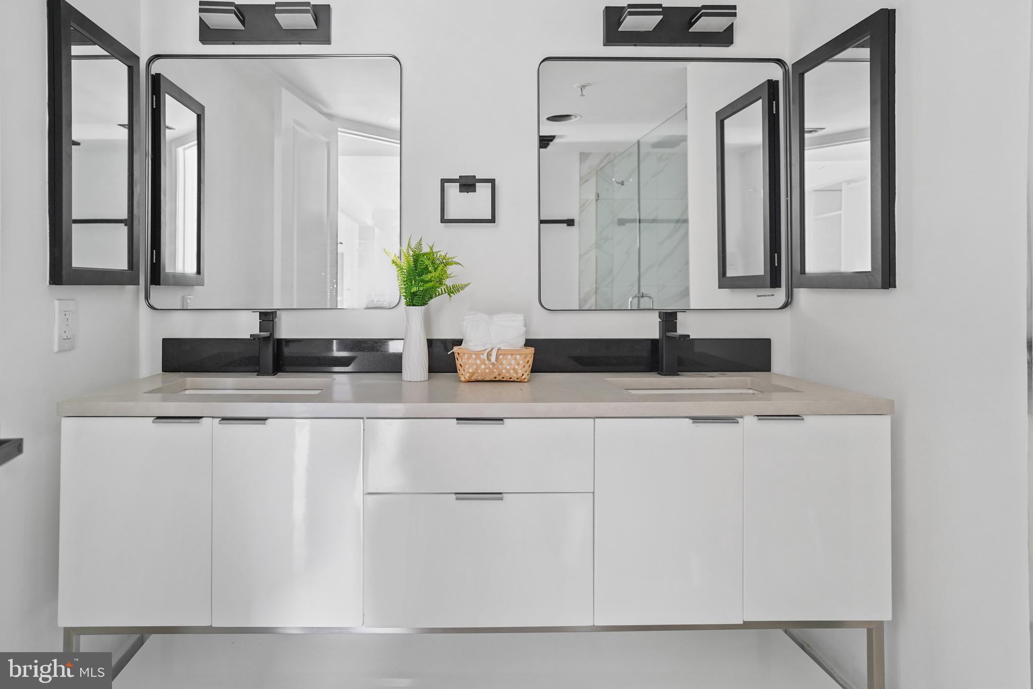 5000 Battery Lane, Unit 501 Bethesda, MD 20814 - Photo 14 of 21 a bathroom with a granite countertop sink and a mirror