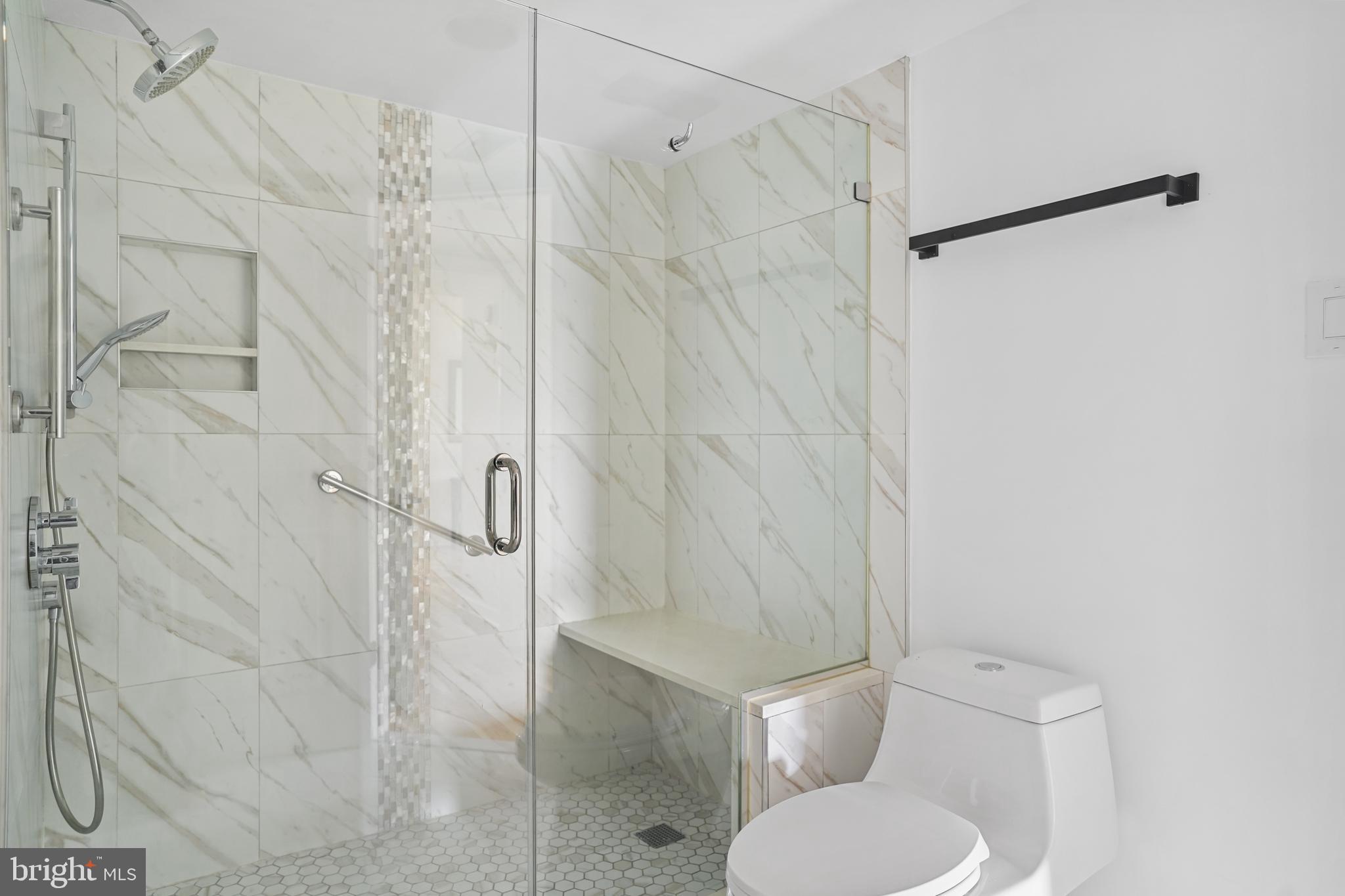 5000 Battery Lane, Unit 501 Bethesda, MD 20814 - Photo 15 of 21 a white toilet sitting next to a shower curtain