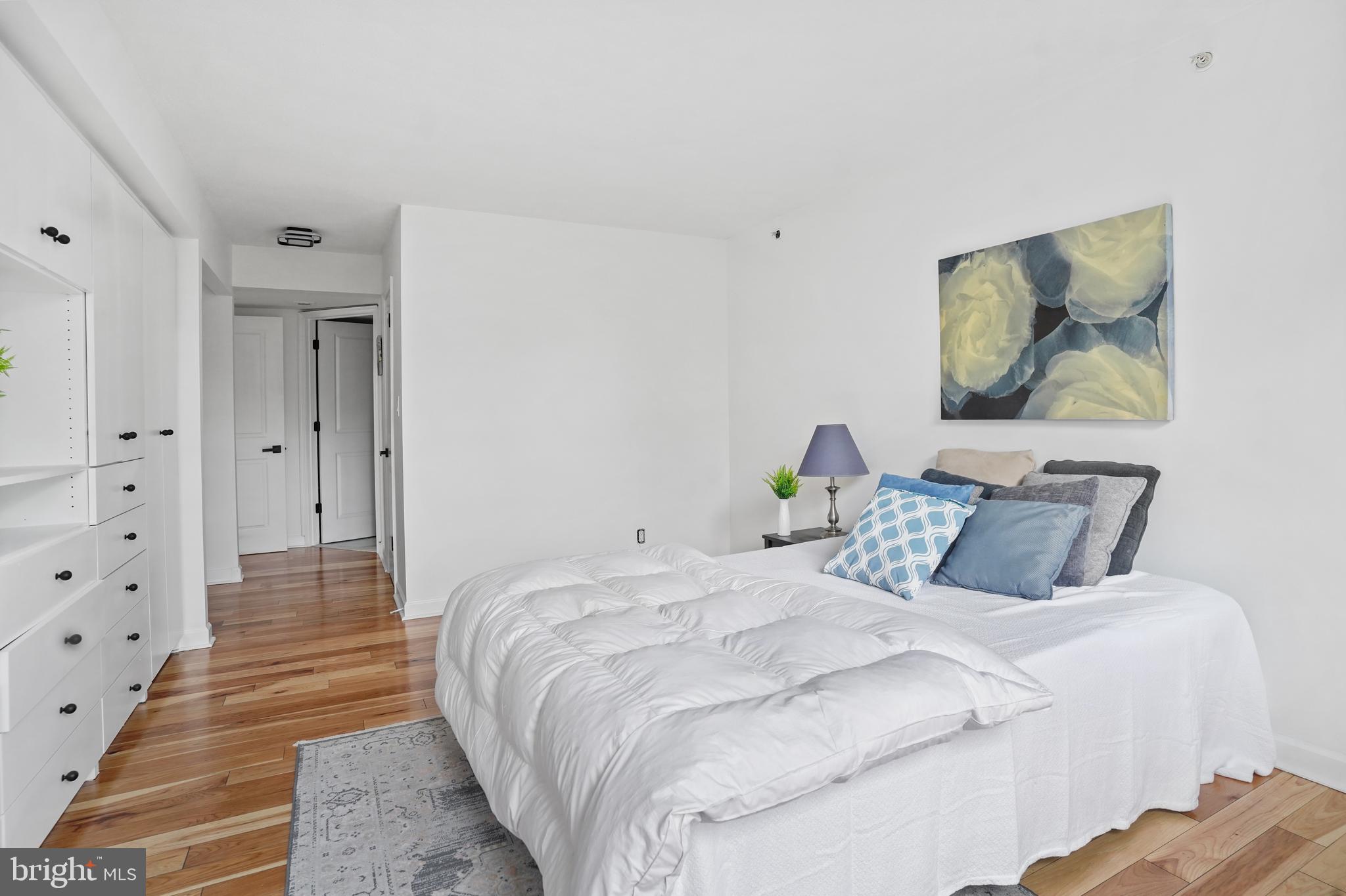 5000 Battery Lane, Unit 501 Bethesda, MD 20814 - Photo 7 of 21 a bedroom with a bed and a painting on the wall