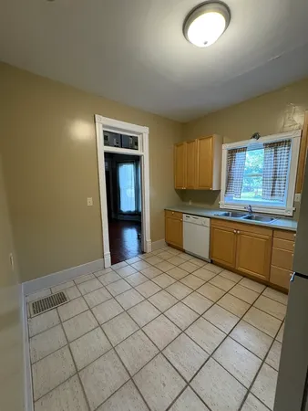 a kitchen with stainless steel appliances granite countertop a sink and cabinets with wooden floor